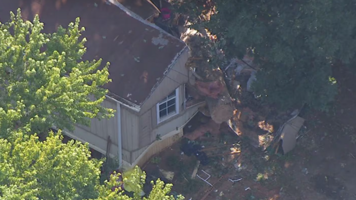 Tree crashes into Huntersville home, traps someone underneath, rescuers say